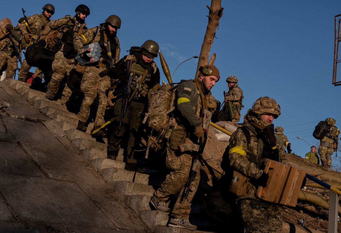 Eastern Europe - Ukraine, Irpin: Ukranian soldiers carrying emonition as the head  into the city of Irpin which has been heavily attacked and destroyed by the Russian army.
